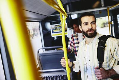 Man standing in bus. Man standing in bus.